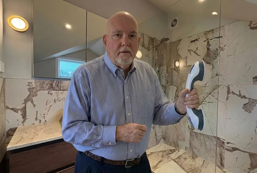Man installing Gripstead Pro bathroom safety handle